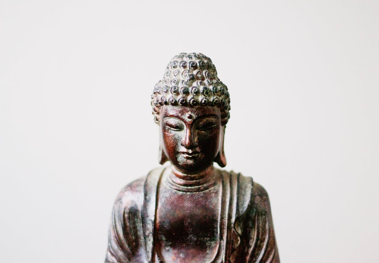 Detailed close-up of a Buddha statue embodying serenity and spiritual culture.